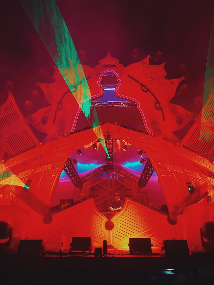 pexels photo 13872115 Dynamic laser and light display with a red structure, creating vibrant visual effects at a nighttime event.